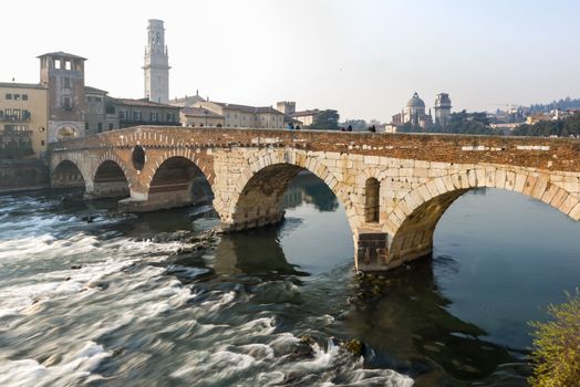 Ponte Pietra on river Adige, ancient roman bridge in the old town of Verona, Italy