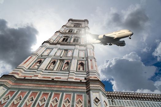 Bottom view of belfry tower of Florence Duomo, Santa Maria Del Fiore, on cloudy grey sky background with a plane.