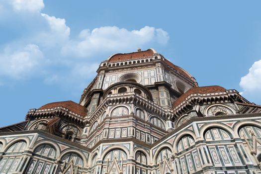 Bottom view of famous historical Florence Duomo, Santa Maria Del Fiore, on cloudy blue sky background.