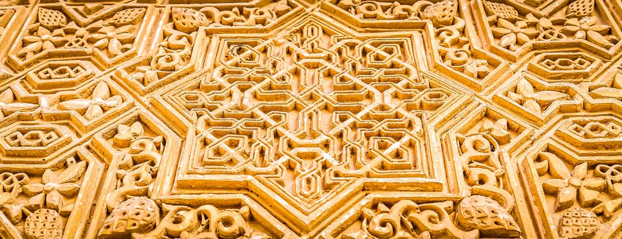 Wall detail of Alhambra UNESCO site in Granada - South of Spain. 600 years old arabic characters.