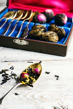 Aromatic teas and a set of spoons on a light background