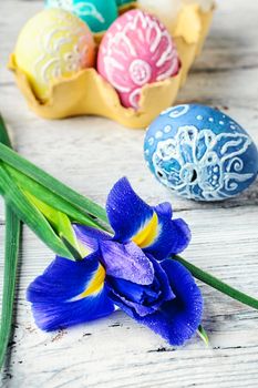 Iris flower painted and decorated Easter egg on light background