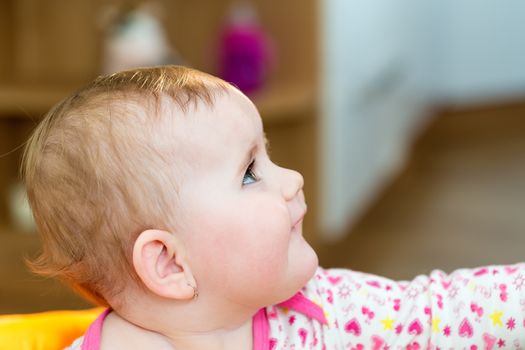 Happy cute little one year old girl indoor in white pink dress