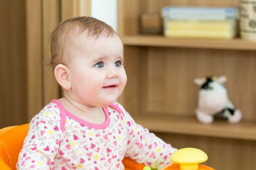 Happy cute little one year old girl indoor in white pink dress