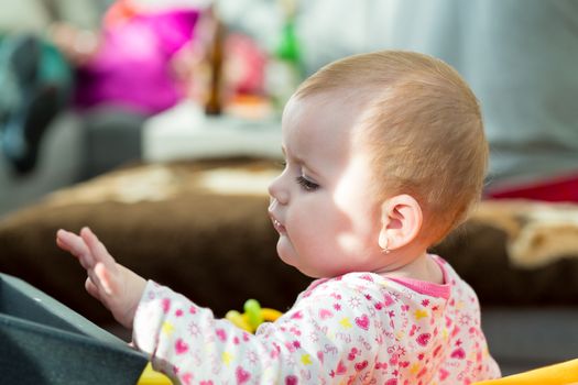 Happy cute little one year old girl indoor in white pink dress