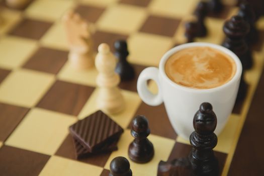 Leisure relax time or business strategy concept. Part of chess table with coffee cup hot drink 