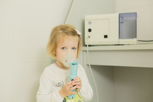 Girl with asthma inhaler. Girl with asthma or allergy problems making inhalation with mask on her face. Inhalation treatment of respiratory diseases. Shallow depth of field