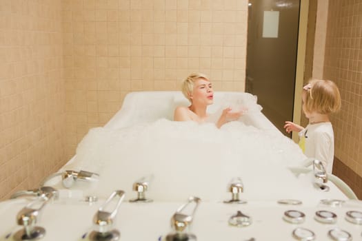 A woman and a hydro massage. She receives medical treatments for relaxation.