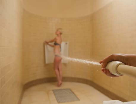 The woman having high pressure massage with Sharko shower