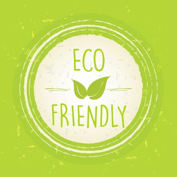 eco friendly with leaf sign in circle with rings over green old paper background
