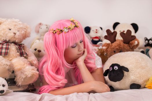 young girl in a bedroom in a pink cute dress