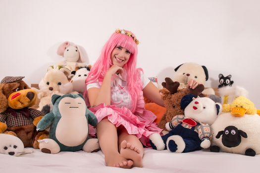 young girl in a bedroom in a pink cute dress