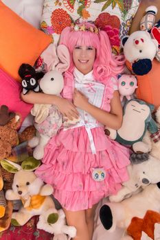 young girl in a bedroom in a pink cute dress