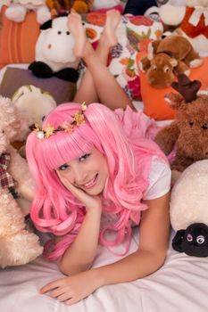 young girl in a bedroom in a pink cute dress