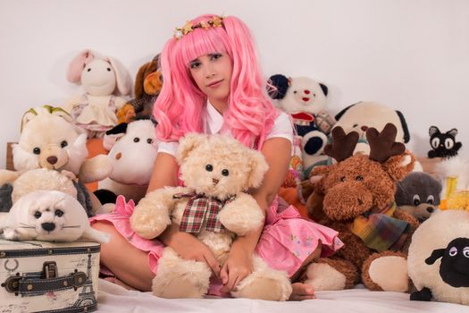 young girl in a bedroom in a pink cute dress