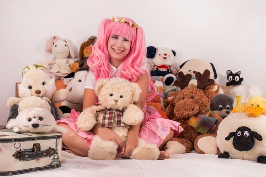 young girl in a bedroom in a pink cute dress