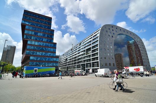 Rotterdam, Netherlands - May 9, 2015: People visit Market hall near blaak station in Rotterdam. The covered food market and housing development shaped like a giant arch by Dutch architects MVRDV.