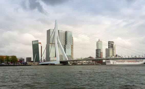 Rotterdam, Netherlands - May 9, 2015: Erasmus Bridge with Skyscraper in Rotterdam, The Netherlands. Rotterdam has always been one of the main centres of the shipping industry in the Netherlands.