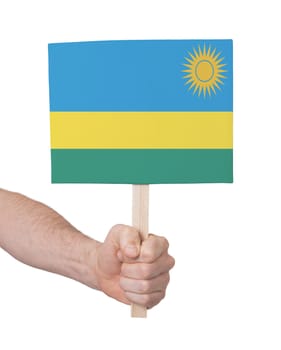 Hand holding small card, isolated on white - Flag of Rwanda