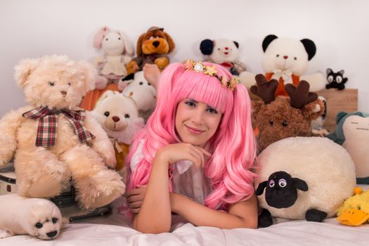 young girl in a bedroom in a pink cute dress