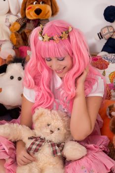 young girl in a bedroom in a pink cute dress