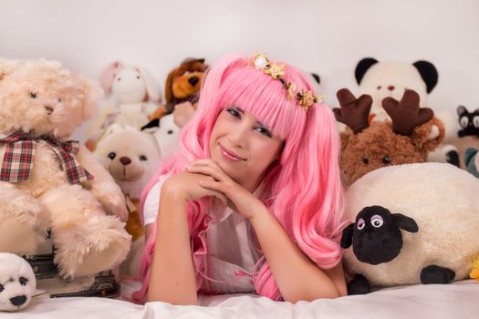 young girl in a bedroom in a pink cute dress