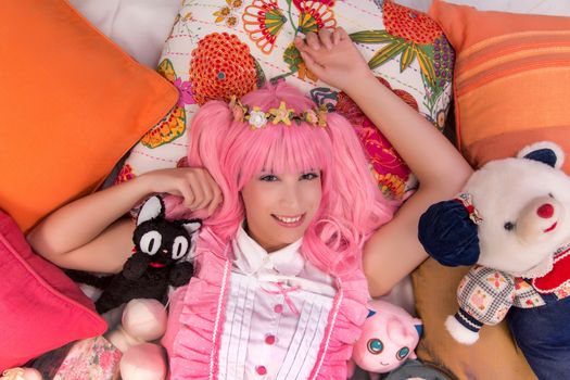 young girl in a bedroom in a pink cute dress