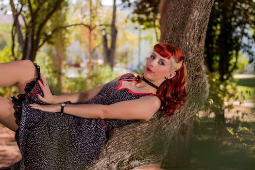 View of a young woman with a simple spring dress posing on the park.