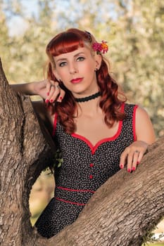 View of a young woman with a simple spring dress posing on the park.