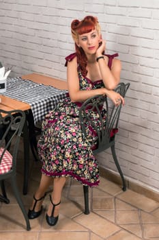 View of a young woman inside a coffee shop having breakfast.