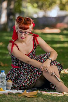 View of a young woman having a picnic in the park.