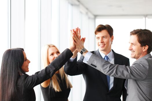 Happy business people hands giving high five 