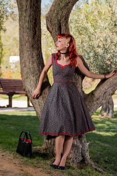 View of a young woman with a simple spring dress posing on the park.