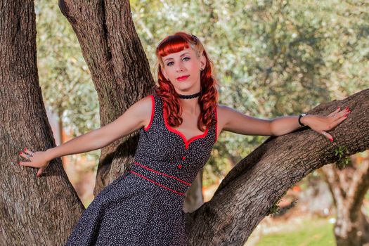 View of a young woman with a simple spring dress posing on the park.