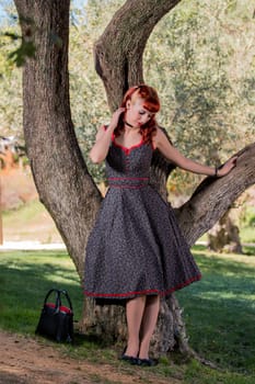 View of a young woman with a simple spring dress posing on the park.