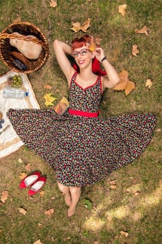 View of a young woman having a picnic in the park.