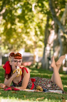 View of a young woman having a picnic in the park.