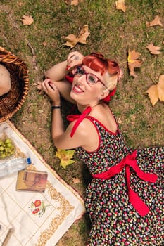 View of a young woman having a picnic in the park.