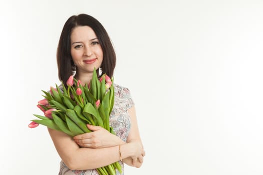 the beautiful woman holds a bouquet of tulips