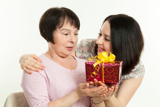 the woman gives to mother a gift