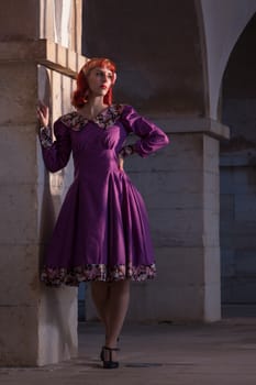 Close up view of a young redhead girl on a retro vintage dress on the urban city.