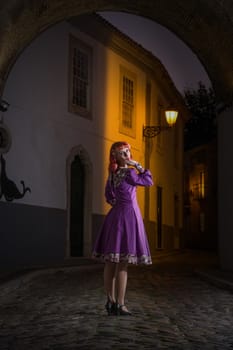 Close up view of a young redhead girl on a retro vintage dress on the urban city.