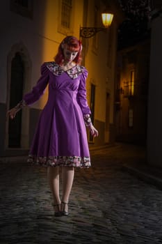 Close up view of a young redhead girl on a retro vintage dress on the urban city.