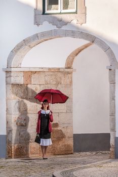 Close up view of a young redhead girl on a retro vintage dress on the urban city.