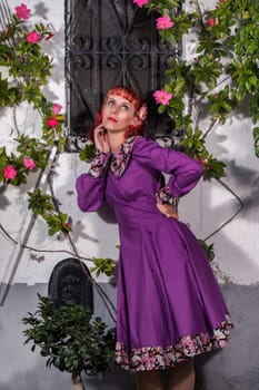 Close up view of a young redhead girl on a retro vintage dress on the urban city.