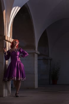 Close up view of a young redhead girl on a retro vintage dress on the urban city.