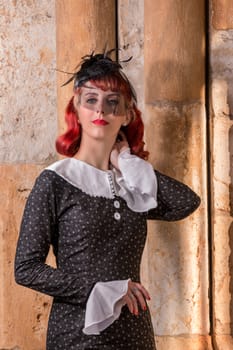 Close up view of a young redhead girl on a retro vintage dress on the urban city.