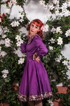 Close up view of a young redhead girl on a retro vintage dress on the urban city.