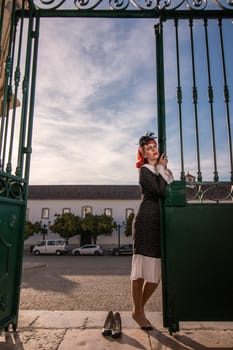 Close up view of a young redhead girl on a retro vintage dress on the urban city.