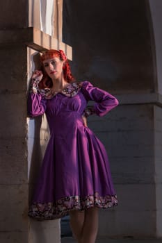 Close up view of a young redhead girl on a retro vintage dress on the urban city.